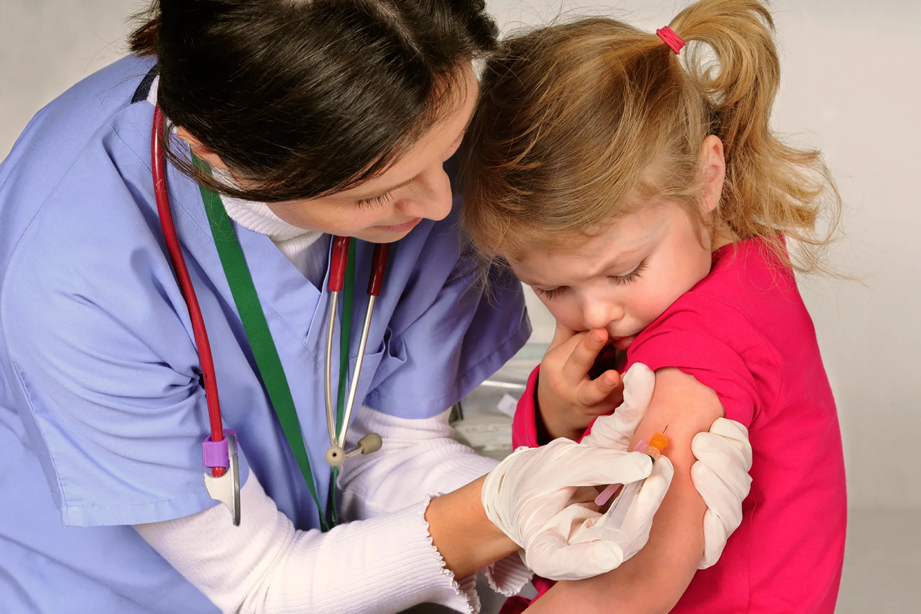 nurse giving child a vaccine