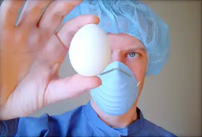 scientist inspecting egg