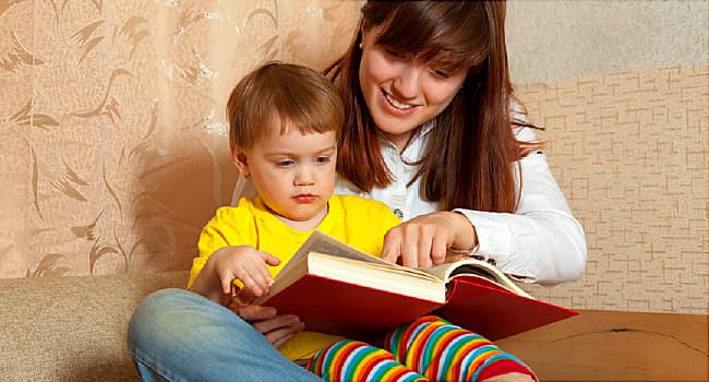 Mother showing book to her baby