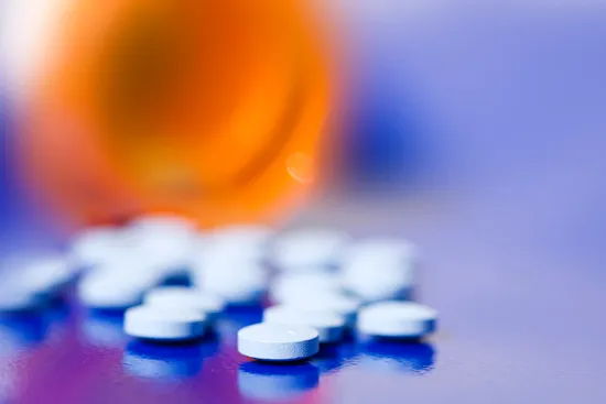 close-up of pills spilling from bottle