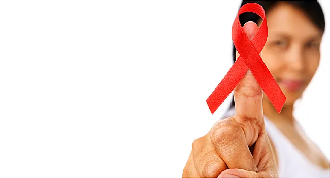 woman holding aids ribbon