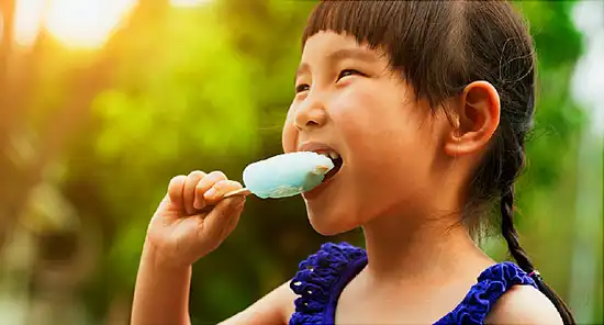 girl eating popsicle