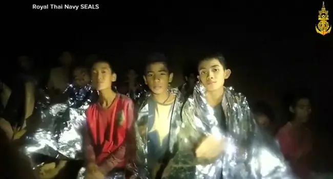 photo of teen boys in cave