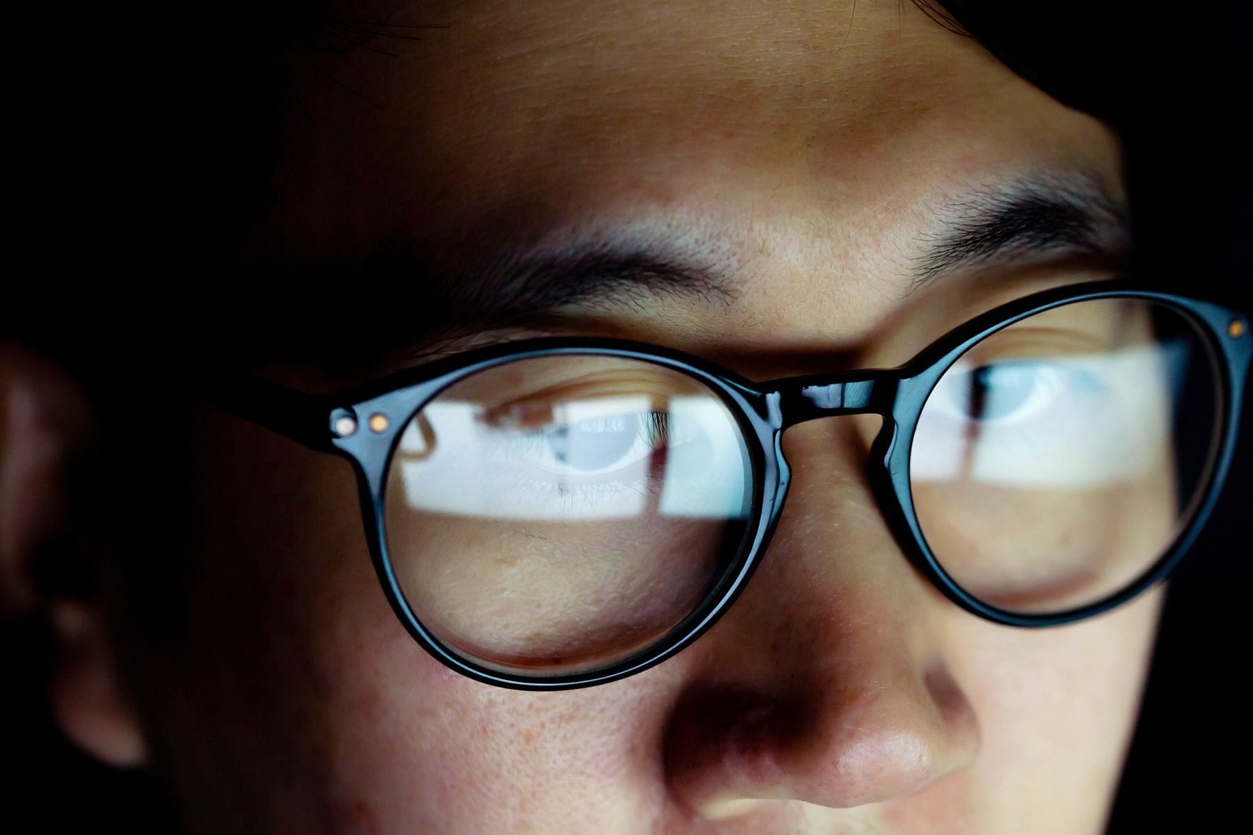 photo of man wearing blue light glasses