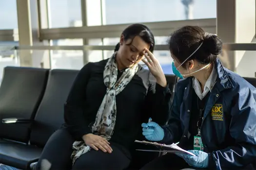 photo of cdc working talking to woman