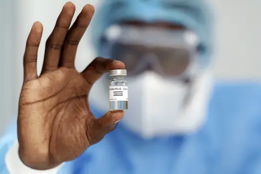 man holding coronavirus vaccine