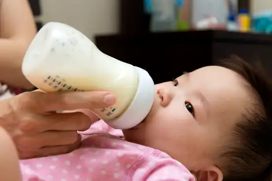 photo of baby bottlefeeding