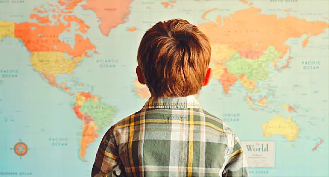 boy looking at world map