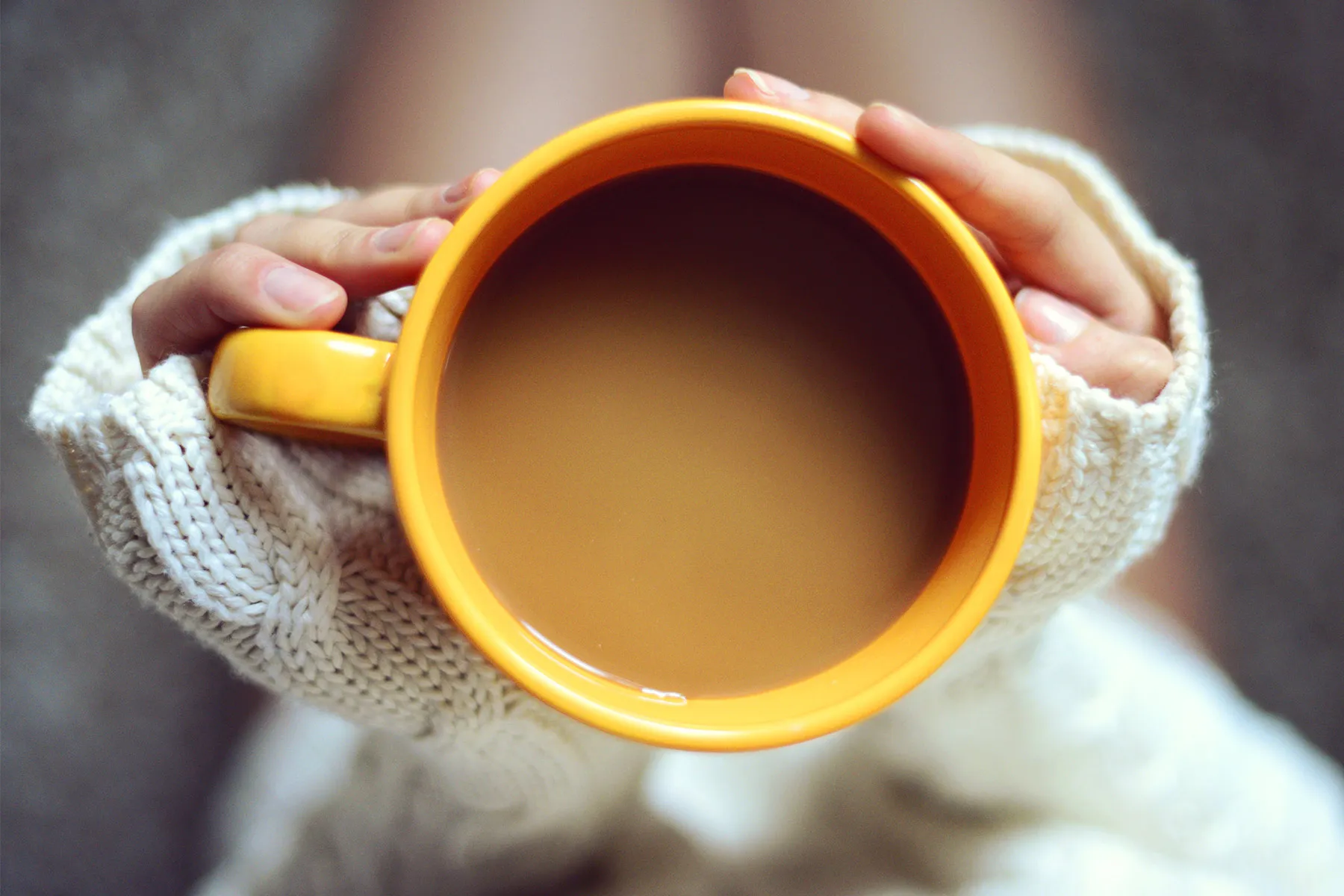 photo of woman holding coffee cup