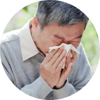 photo of senior man blowing nose