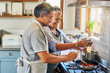 photo of mature couple cooking