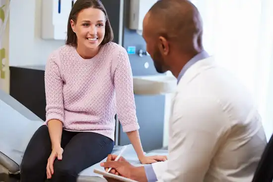 photo of doctor consulting with female patient