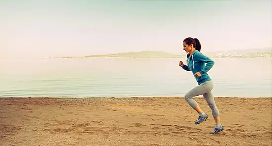 woman jogging on beach