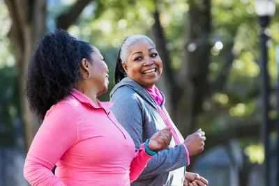 photo of fitness black women walking smiling park