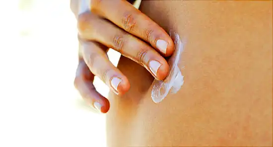 woman applying lotion