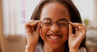 girl with glasses smiling