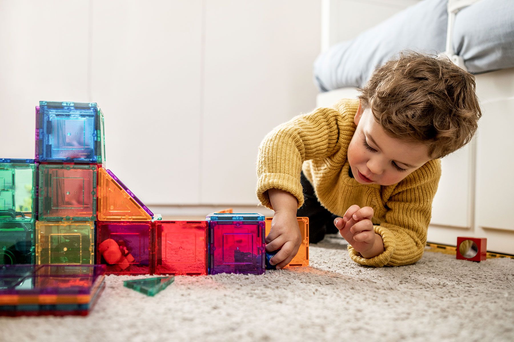 photo of child playing with blocks
