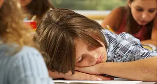 child asleep in classroom
