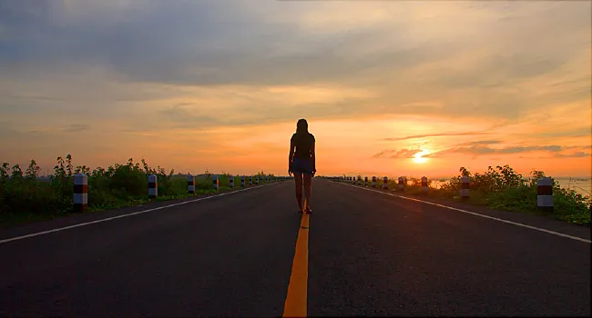 woman walking down road alone