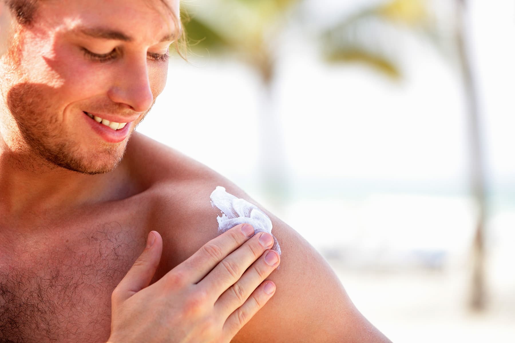 photo of man applying sunscreenphoto of man applyi