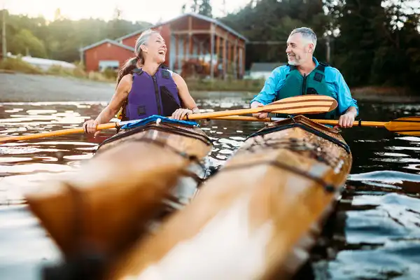 photo of mature couple in kayaks