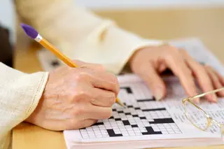 mature woman working crossword puzzlephoto of mature woman working crossword puzzle