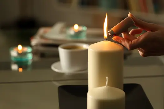 photo of woman lighting candles close up