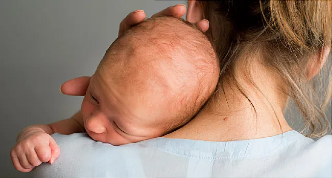 newborn in mothers arms