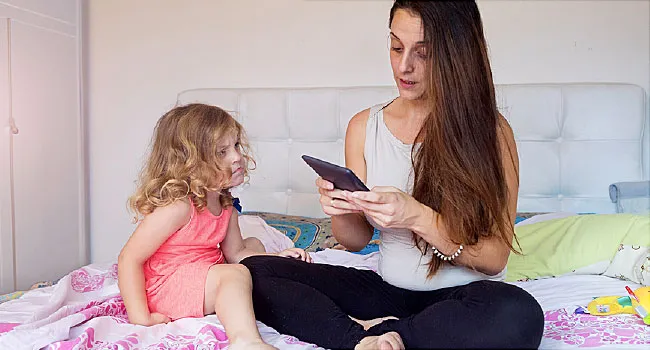 mother using tablet and ignoring daughter