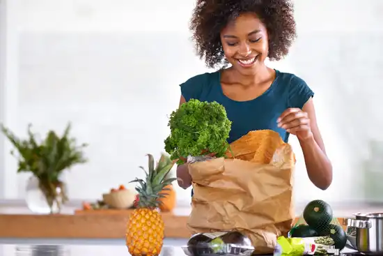 photo of woman at home with groceries