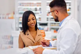 pharmacist assisting customer