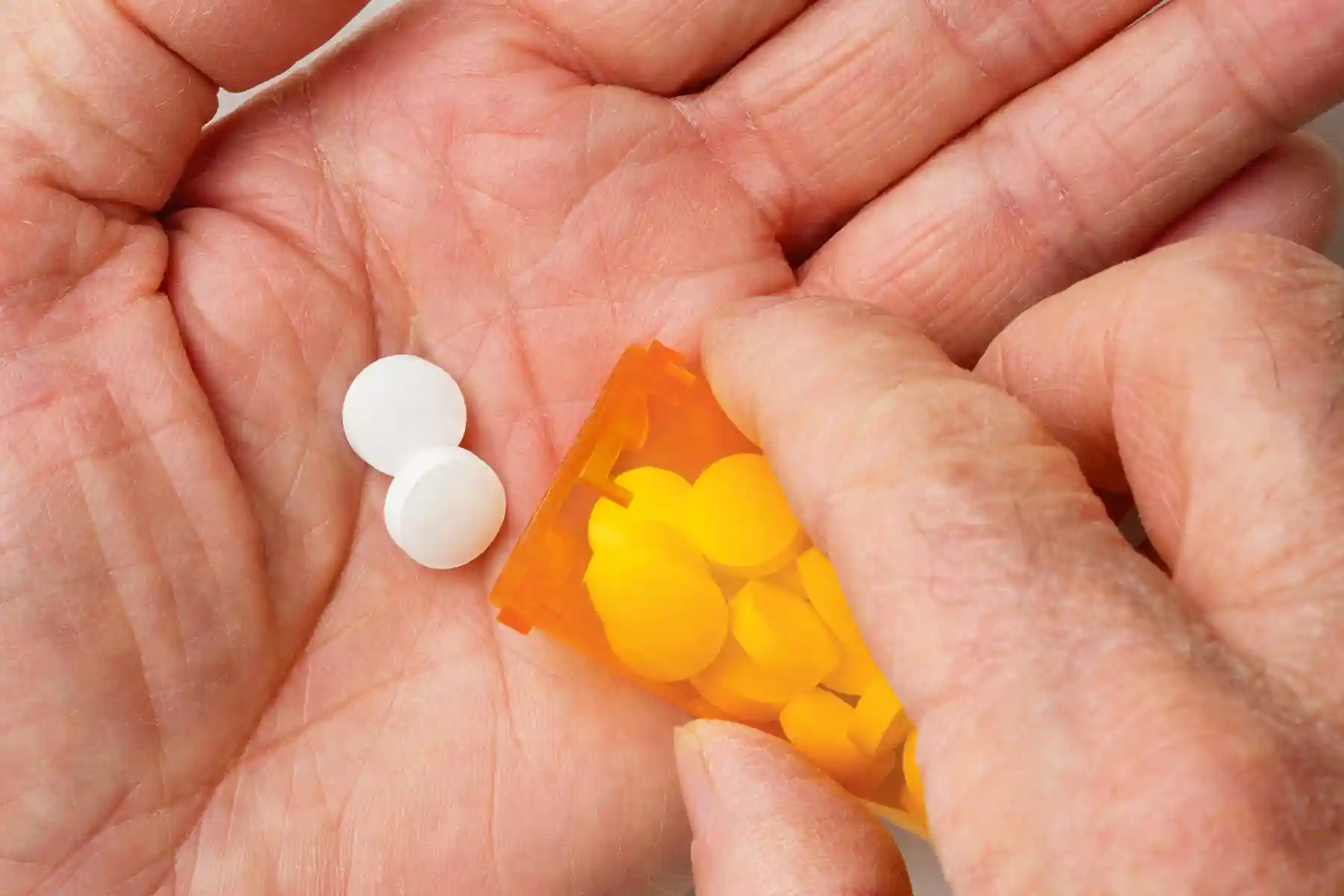photo of pouring prescription pills into hand