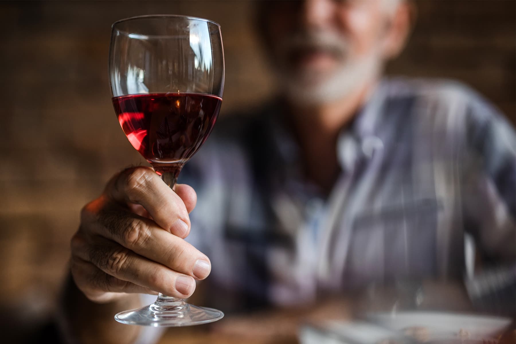 photo of elder  antheral   drinking reddish  wine