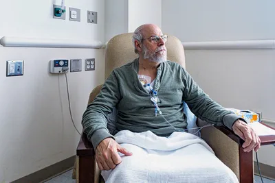 photo of senior man receving chemotherapy treatmen