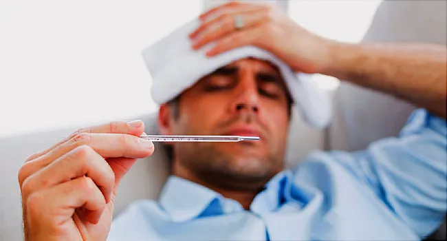 sick man with thermometer