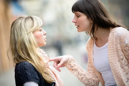 photo of two woman arguing on street
