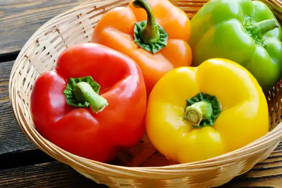 photo of variety of bell peppers in basket