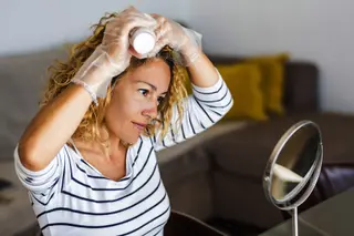 woman coloring hair at home