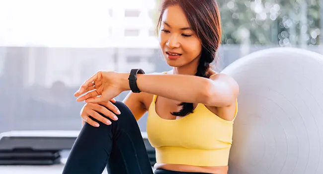 photo of woman looking at smart watch