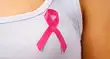 Pink badge on woman chest to support breat cancer