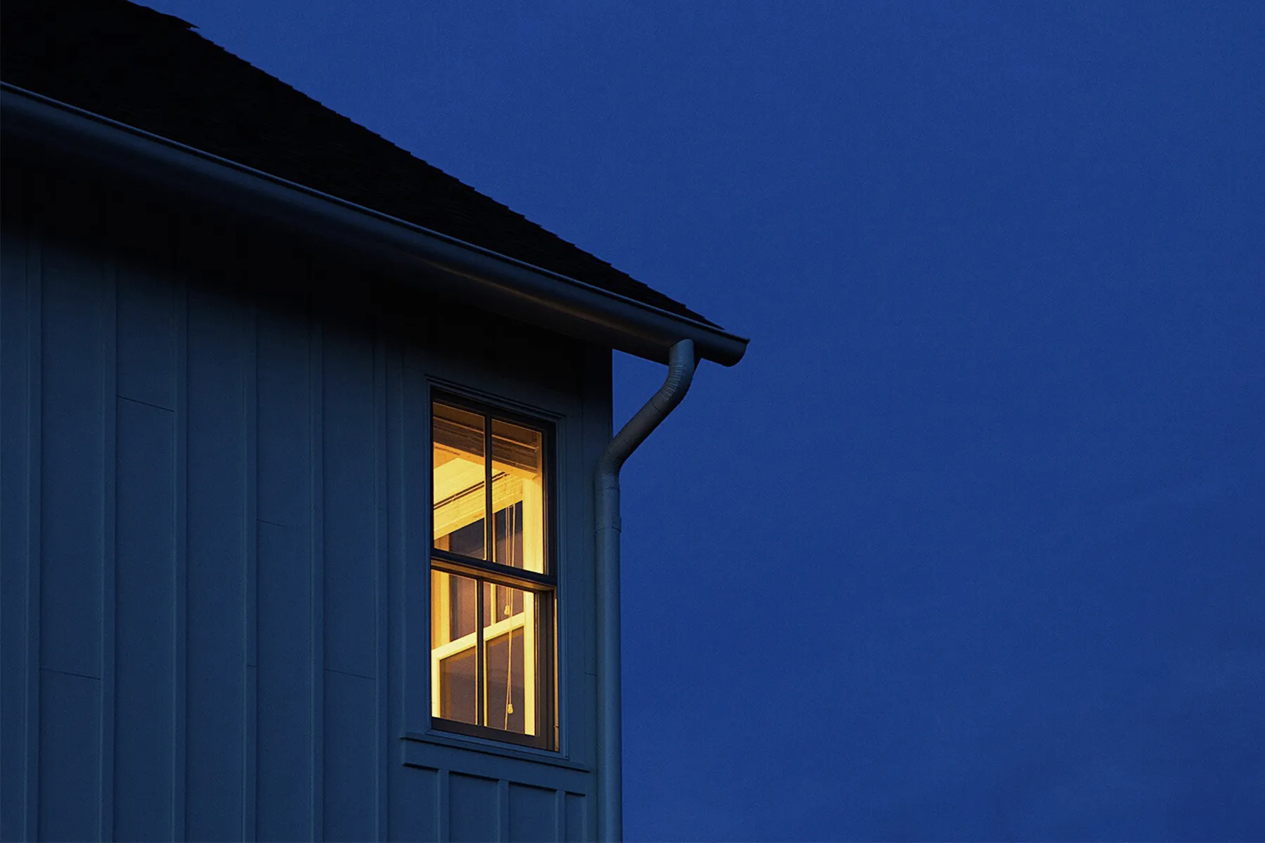lighted window in dark night