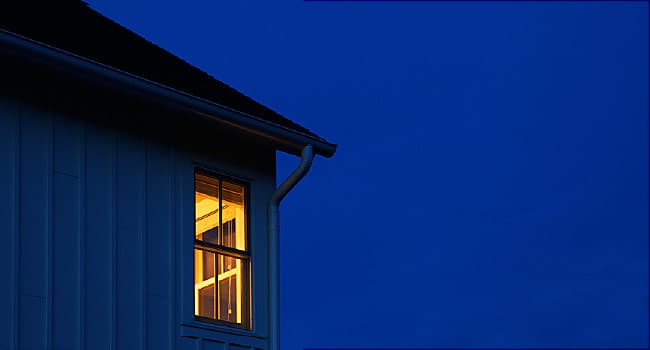 lighted window in dark night