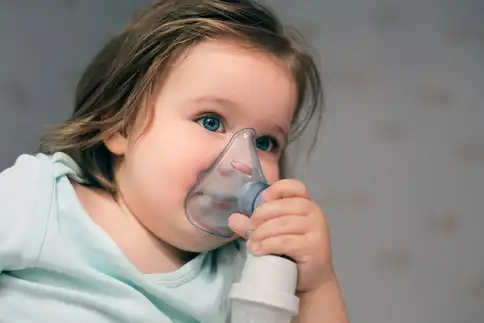 photo of baby girl using oxygen inhaler