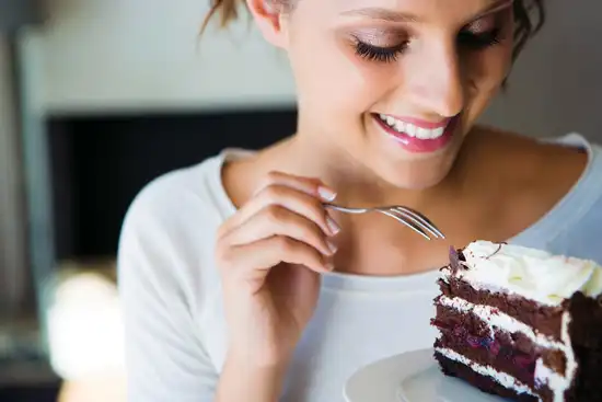 young woman eating cake