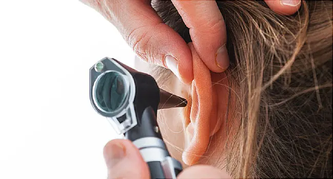 woman ear exam