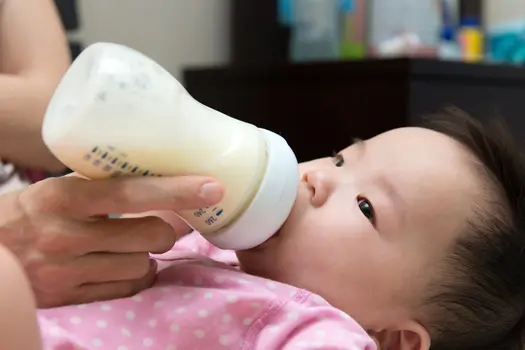 photo of baby drinking from bottle