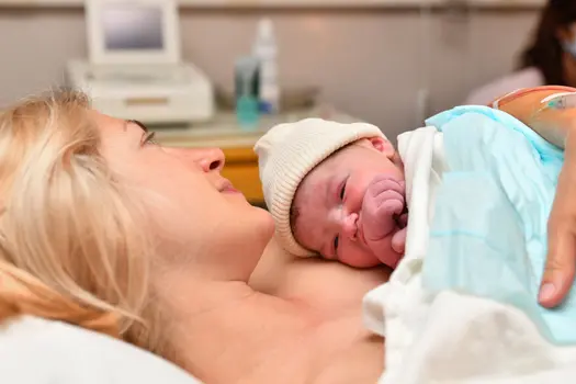 photo of newborn baby on moms chest
