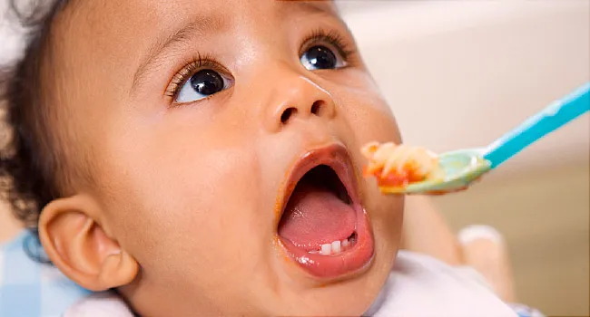 baby eating from spoon