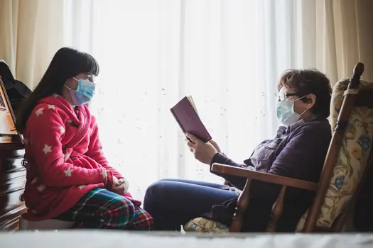 photo of grandmother reading to granddaughter