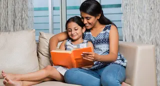 photo of mother reading to daughter